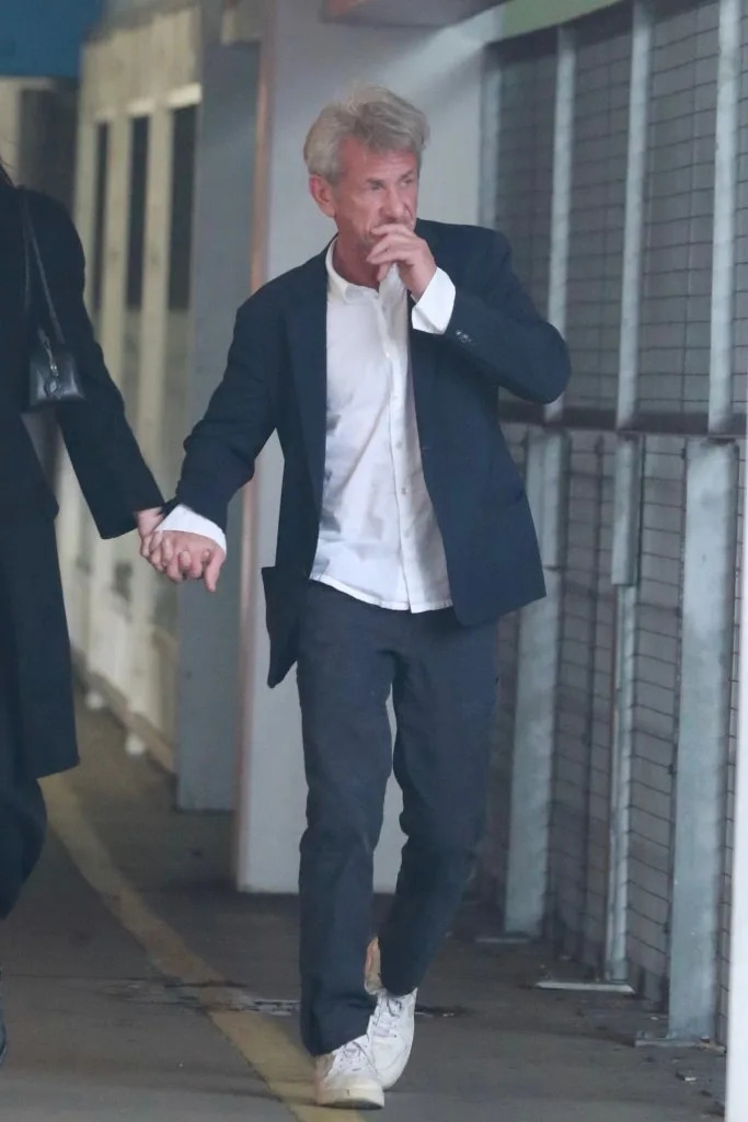 Penn held his opposite hand to his face. BACKGRID