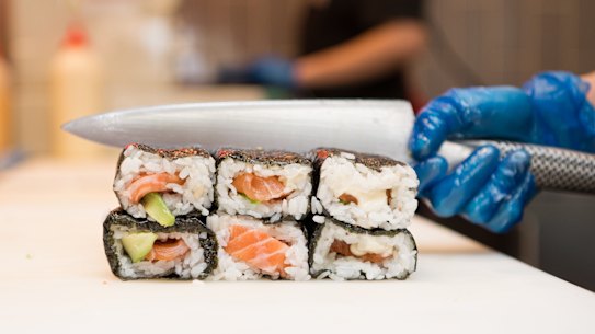 Sushi Hub staff preparing sushi rolls for the lunch rush.
