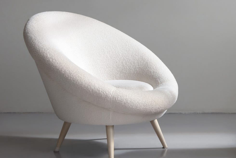 fashionable women's bag on the catwalk and white chair indoors concept retail sale of clothes and accessories