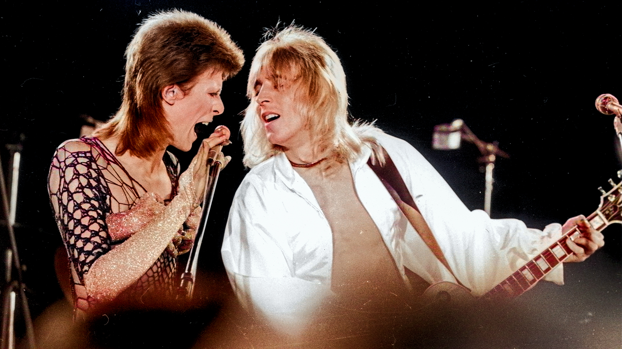 David Bowie (1947 - 2016, left) performing with guitarist Mick Ronson (1946 1993) at a live recording of 'The 1980 Floor Show' for the NBC 'Midnight Special' TV show, at The Marquee Club in London, with a specially invited audience of Bowie fanclub members, 20th October 1973.