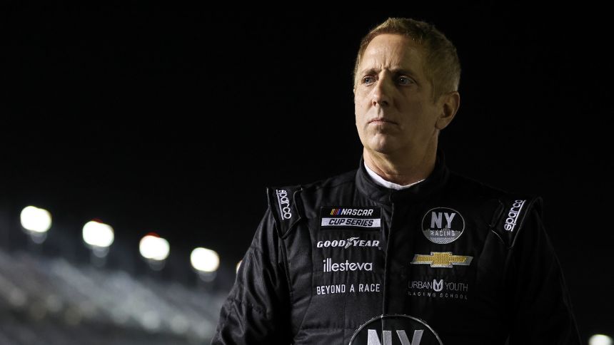 Greg Biffle walks on pit lane during qualifying for a NASCAR Cup Series race in 2022.