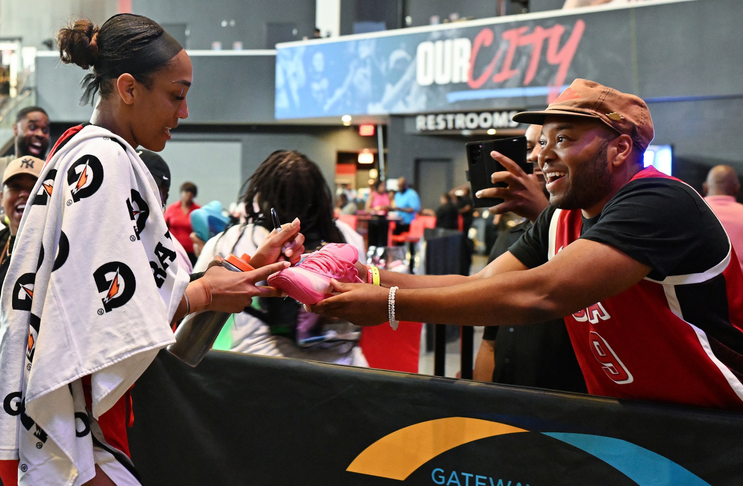 A’ja Wilson autographs an A’One for a fan.