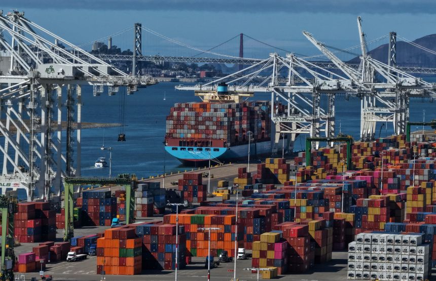 A container ship sits docked at the Port of Oakland.