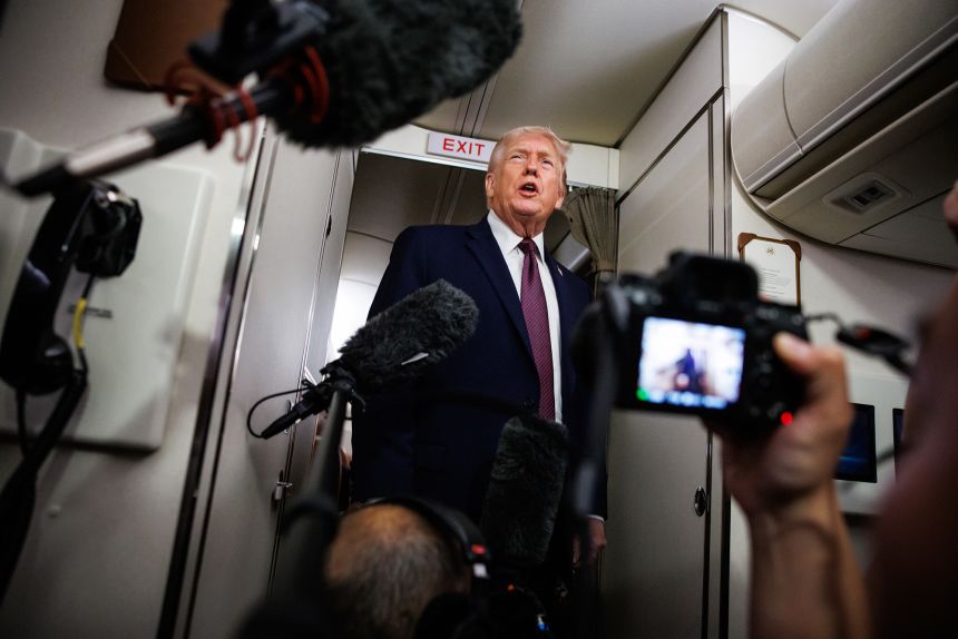 US President Donald Trump takes questions aboard Air Force One on Sunday.