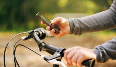 Woman typing text message during bicycle ride