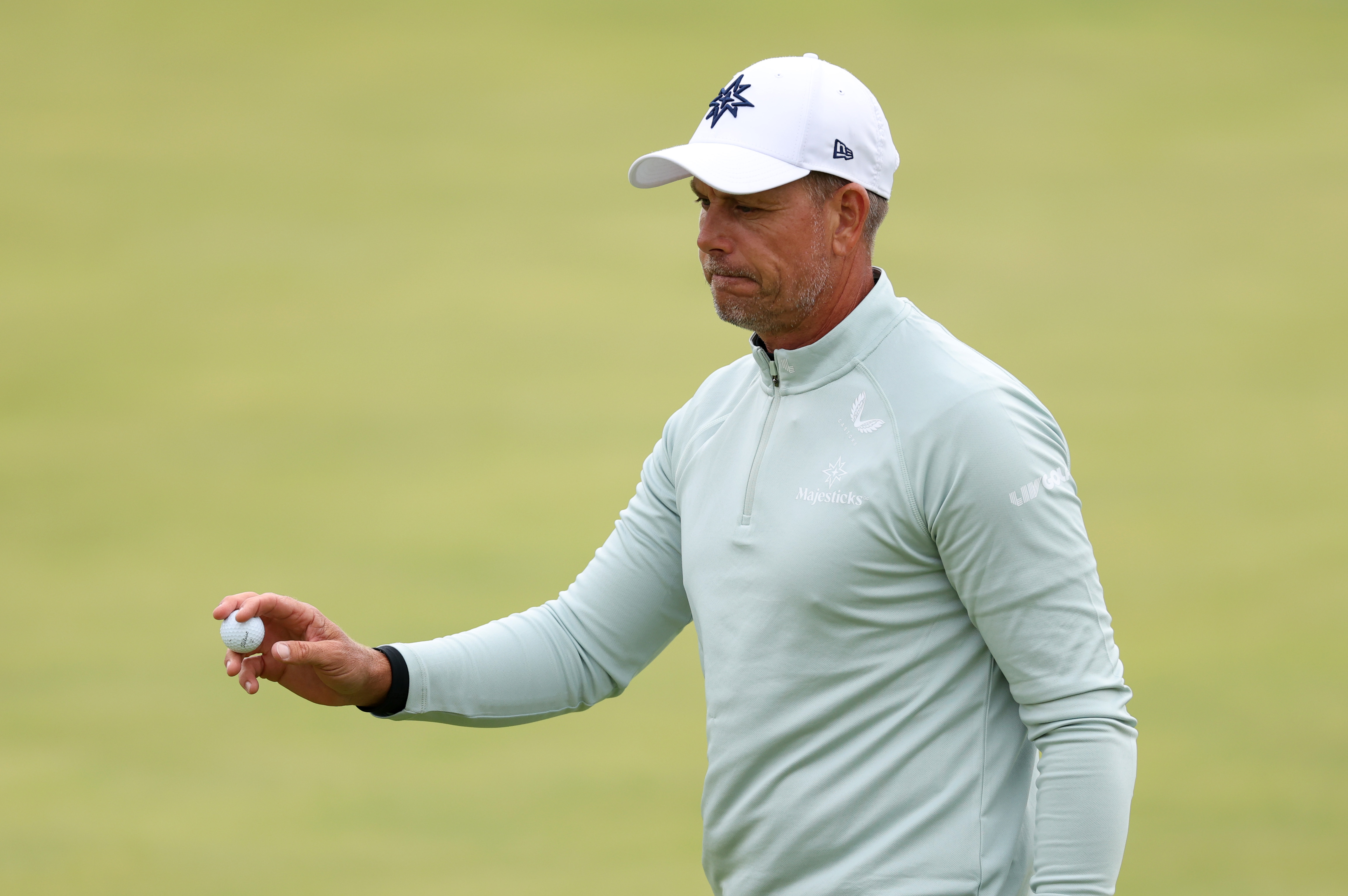 Henrik Stenson waves to the crowd after holing a putt