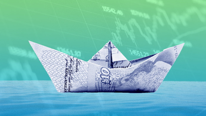 An illustration showing a paper boat made from a £10 note floating on water, with stock market graphs in the background.