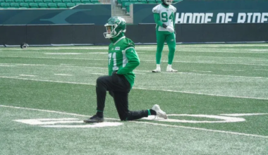 Michael Hughes kneels on the field at Mosaic Stadium.