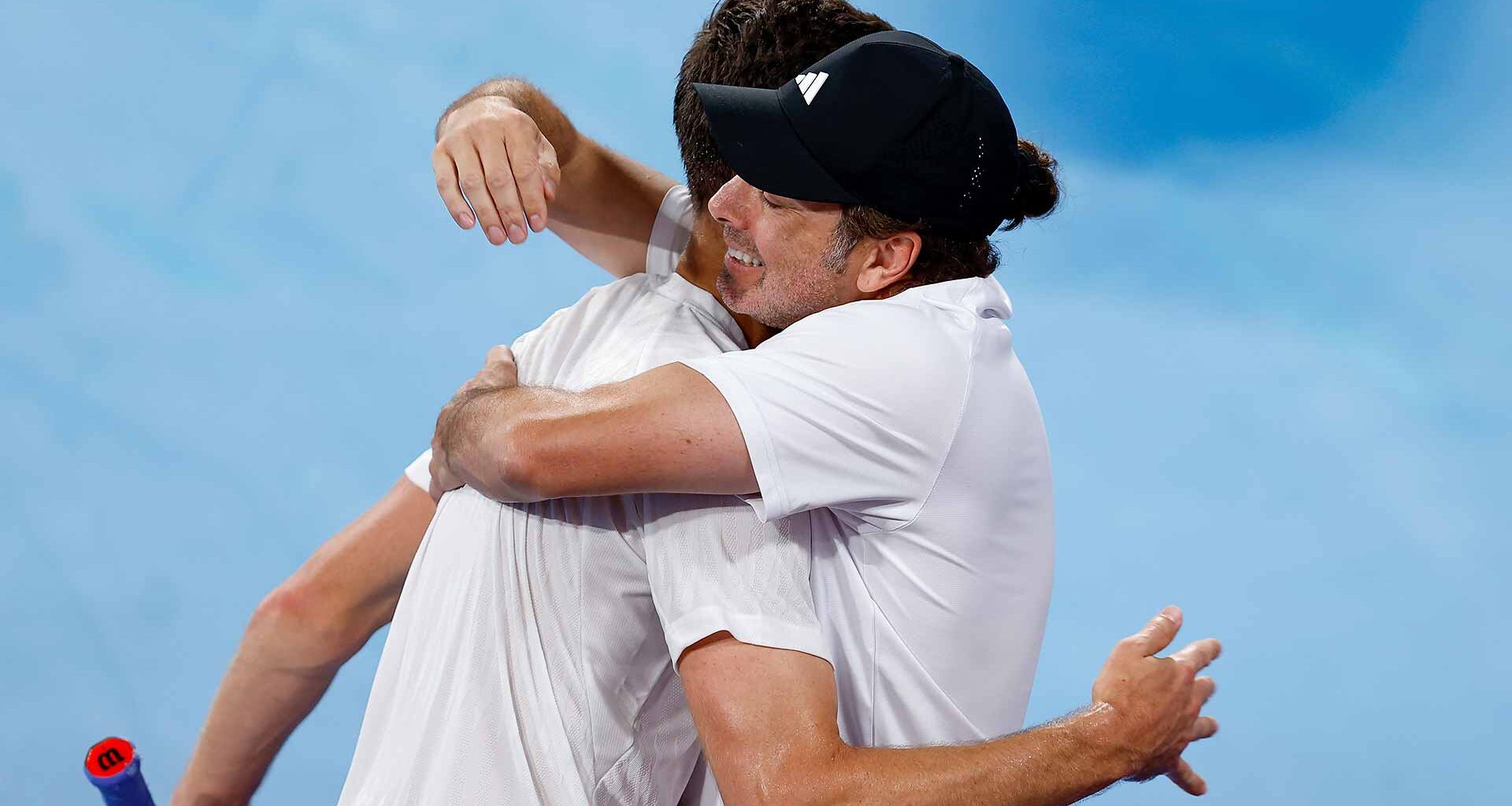 Hubert Hurkacz and Nicolas Massu embrace after Hurkacz's win against Alexander Zverev earlier in the United Cup.
