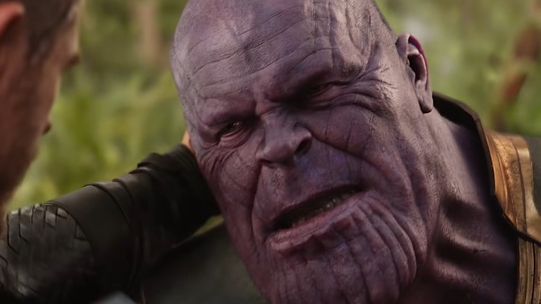 Chris Hemsworth's Thor holding Josh Brolin's Thanos by the neck in Avengers: Infinity War