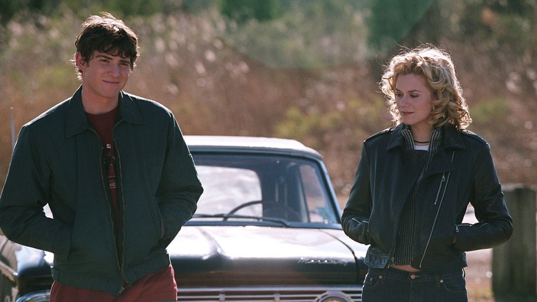 Peyton Sawyer and Jake Jagielski standing in front of car on One Tree Hill