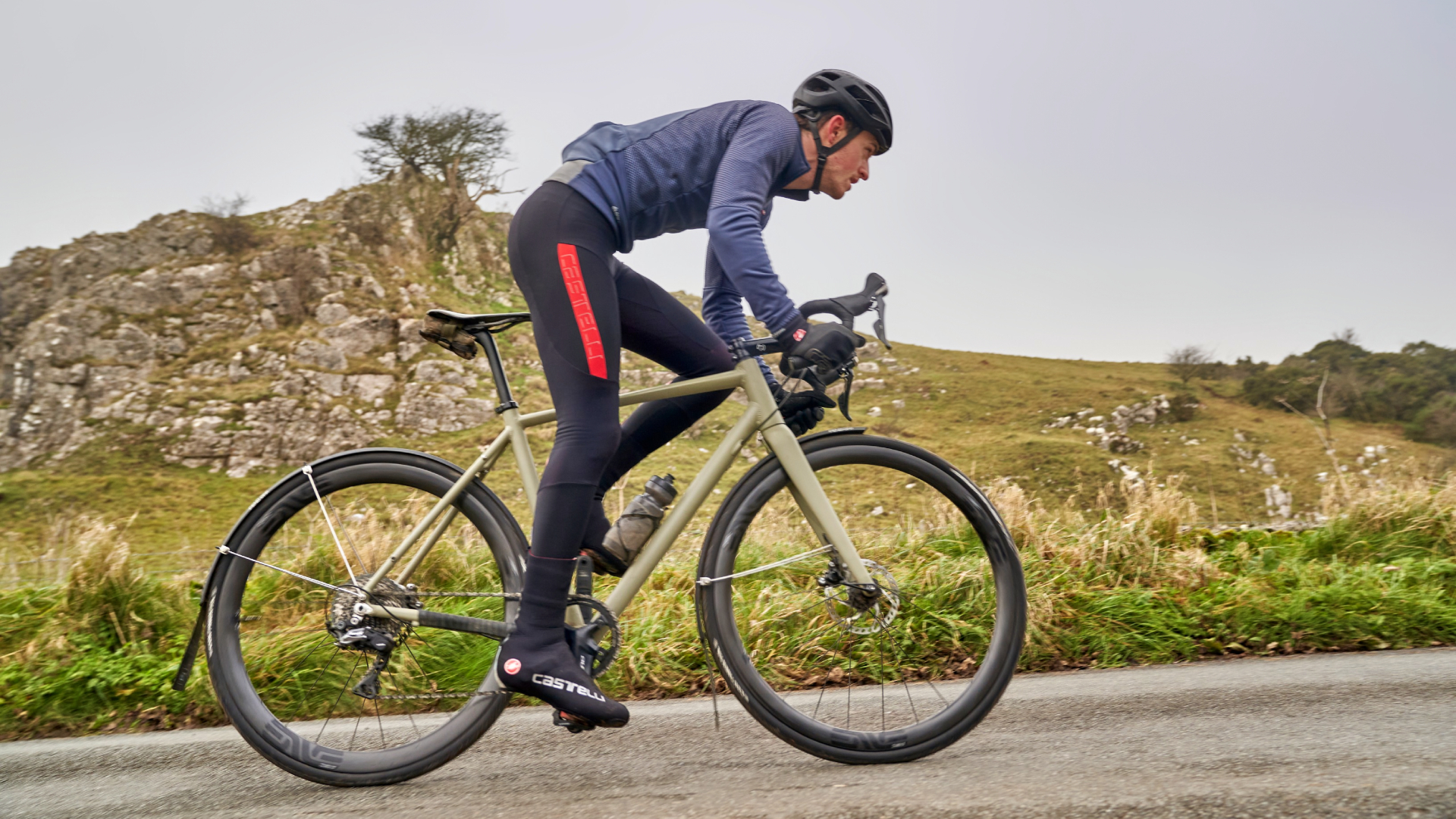 Cyclist riding in winter with a set of full length mudguards