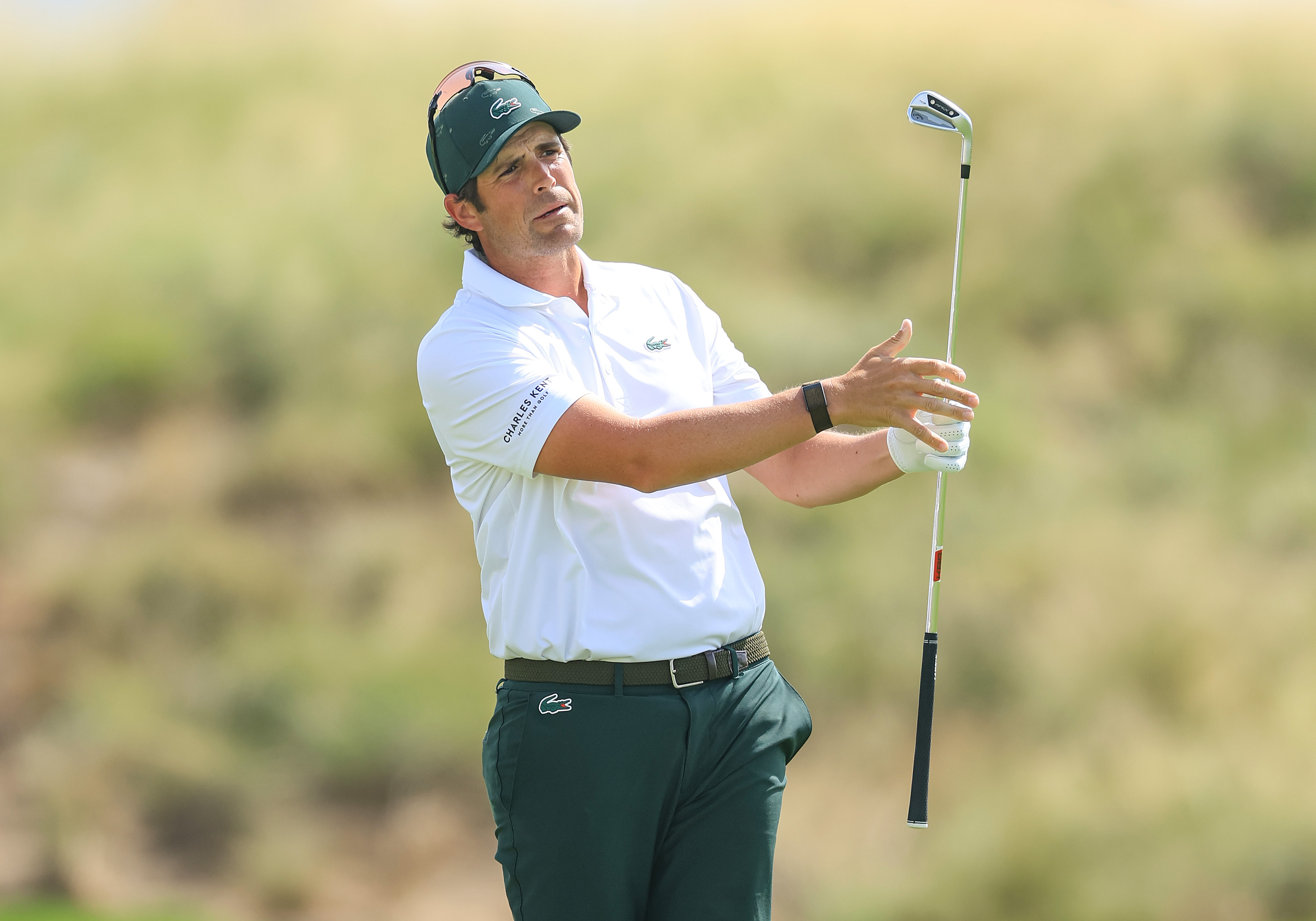 Nacho Elvira hits a wedge shot and watches its flight