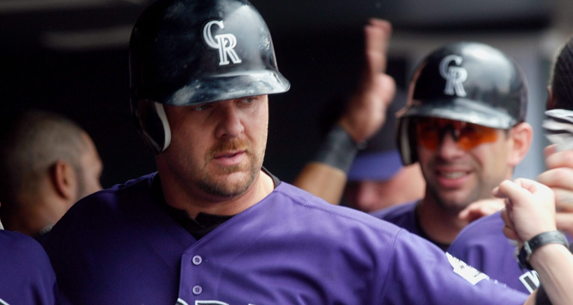 Colorado Rockies' Larry Walker, front, and Todd Helton, rear, are congratulated as they return to the dugout after scoring on a double by teammate Greg Norton in the seventh inning of the Rockies' 5-1 victory in Denver, Sunday May 25, 2003. (David Zalubowski/AP)