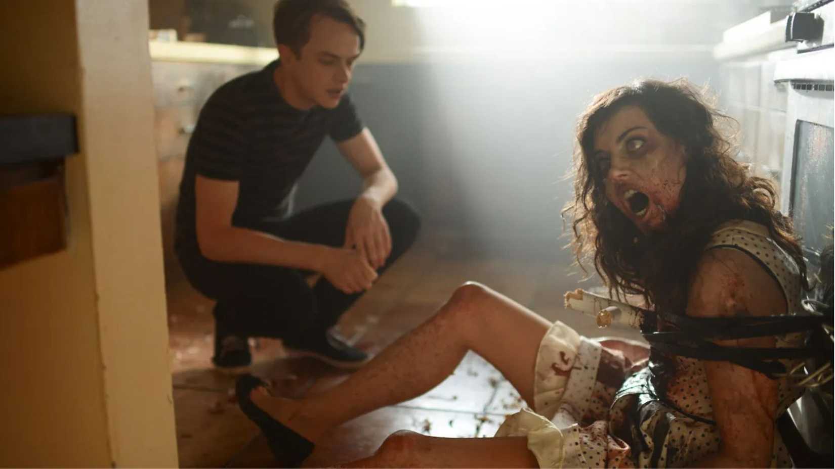Dane DeHaan as Zach kneeling by Aubrey Plaza as Beth in Life After Beth