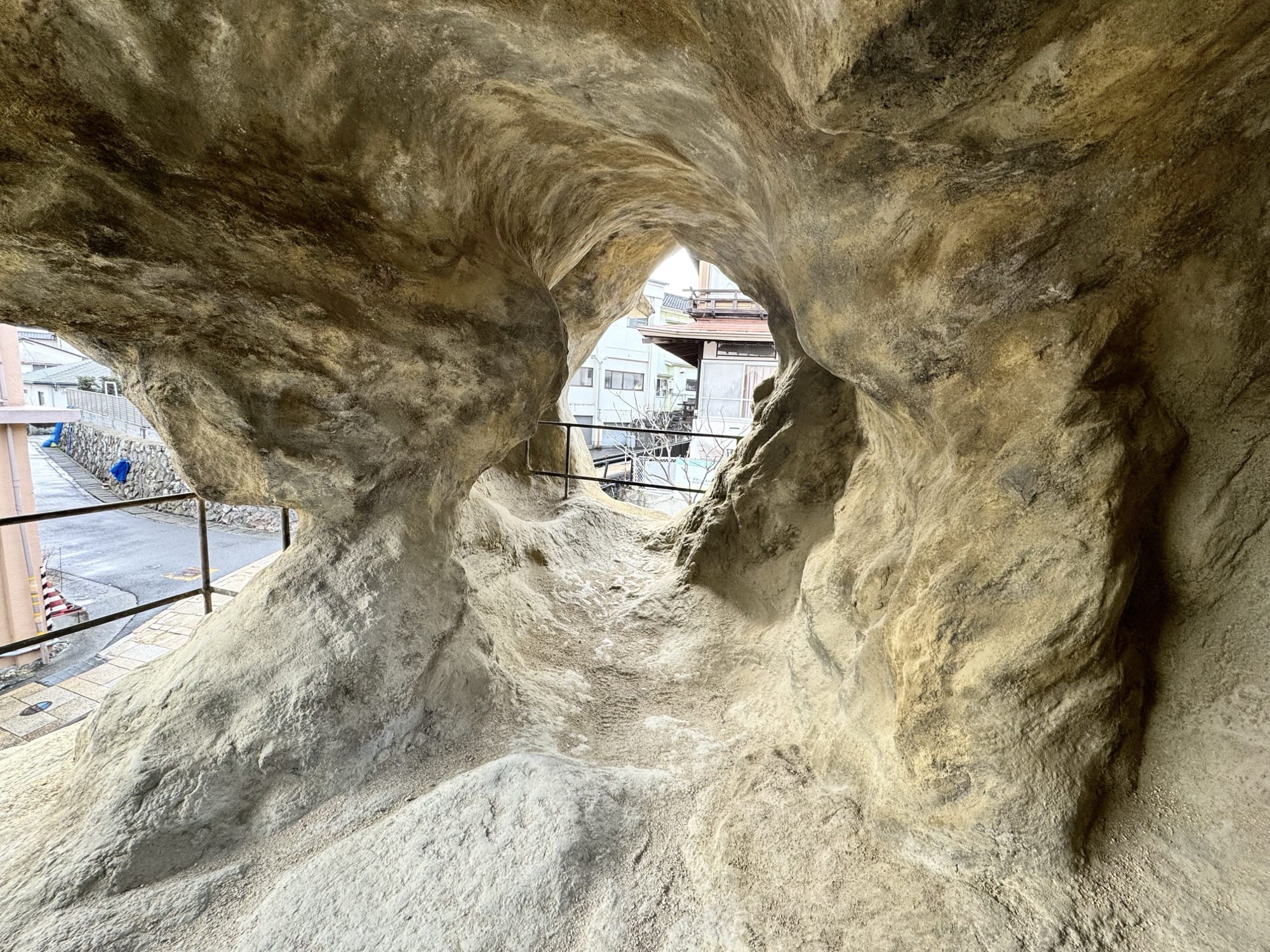 An interior view of an installation comprising a small house that looks like a cave on the inside