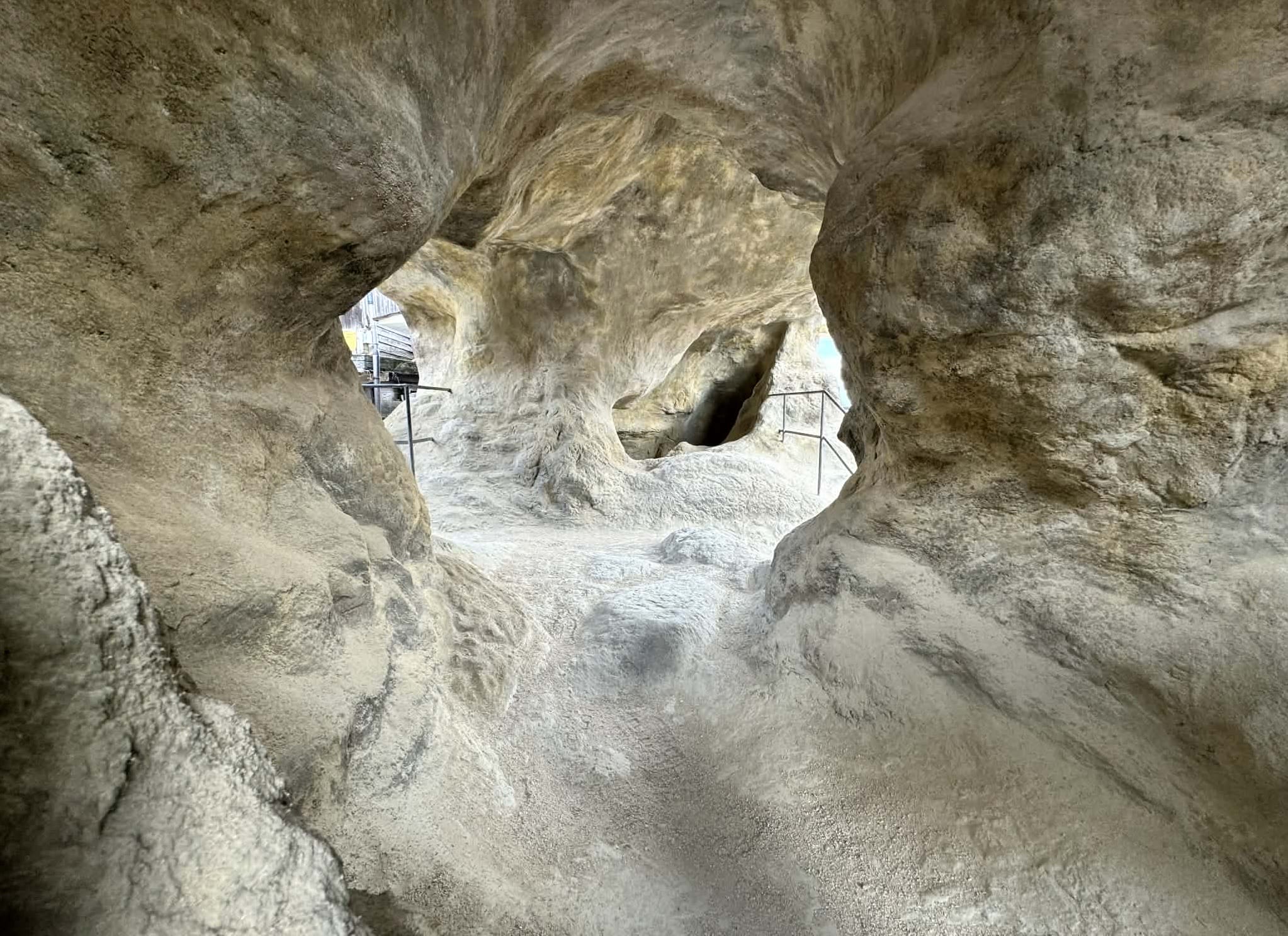 An interior view of an installation comprising a small house that looks like a cave on the inside