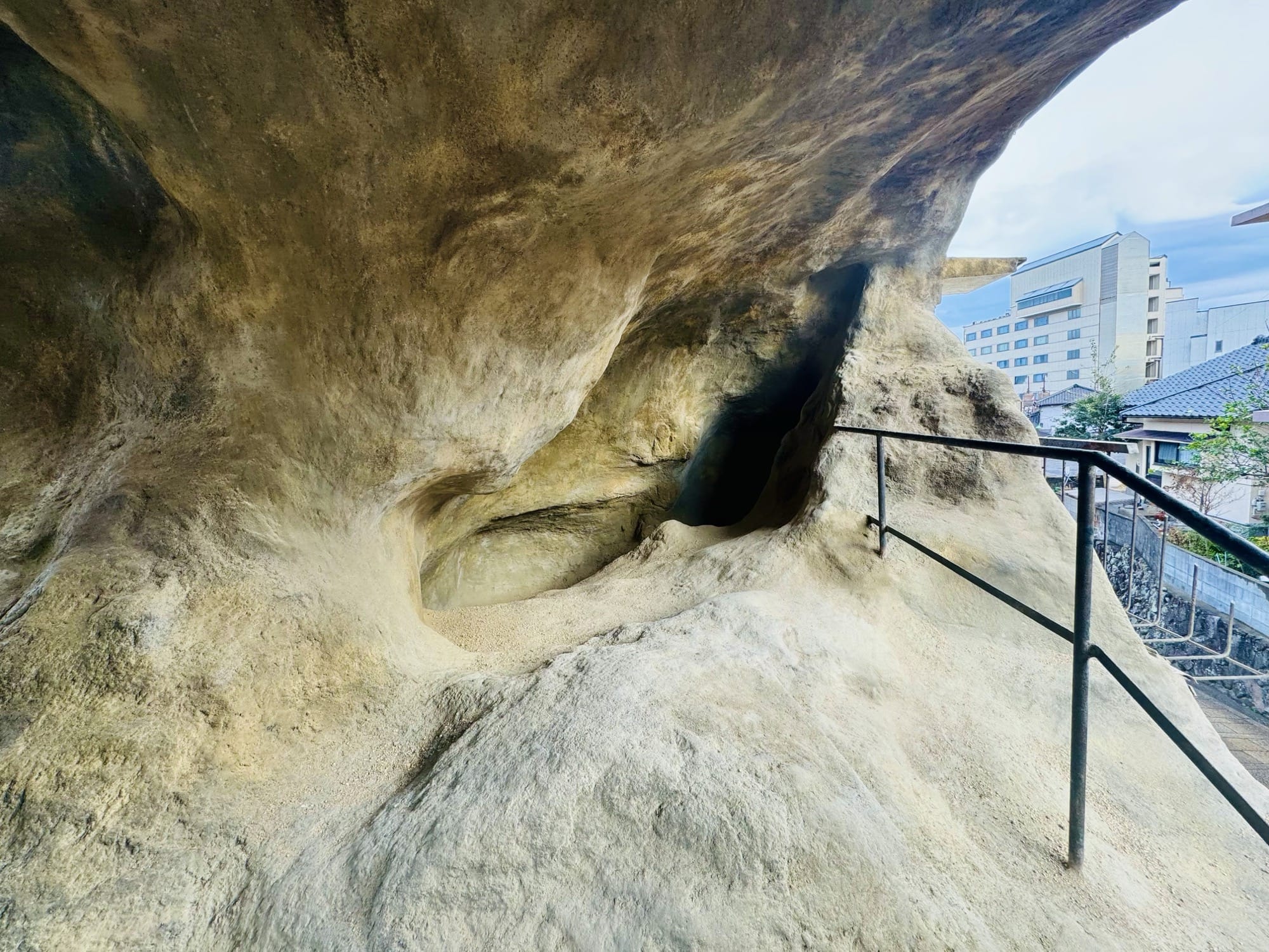 An interior view of an installation comprising a small house that looks like a cave on the inside