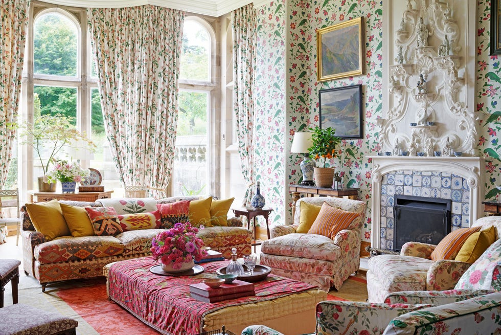 an english country house library with floral fabrics and wallpaper