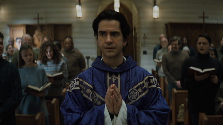 Father Paul Hill (Hamish Linklater) performs Mass on Midnight Mass