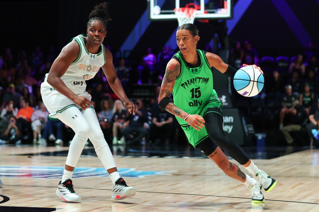 Natasha Cloud of the Phantom drives against Chelsea Gray of the Rose during the fourth quarter of a basketball game.
