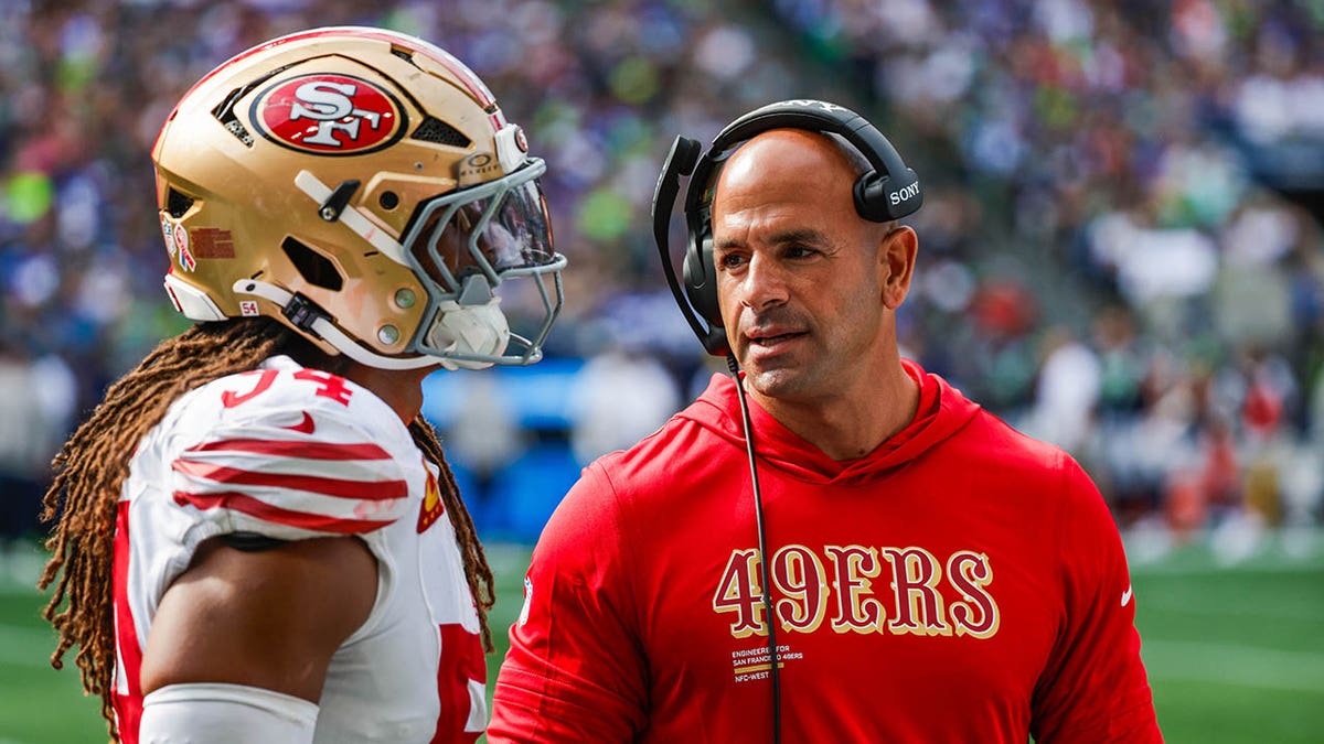 Robert Saleh talks to his player