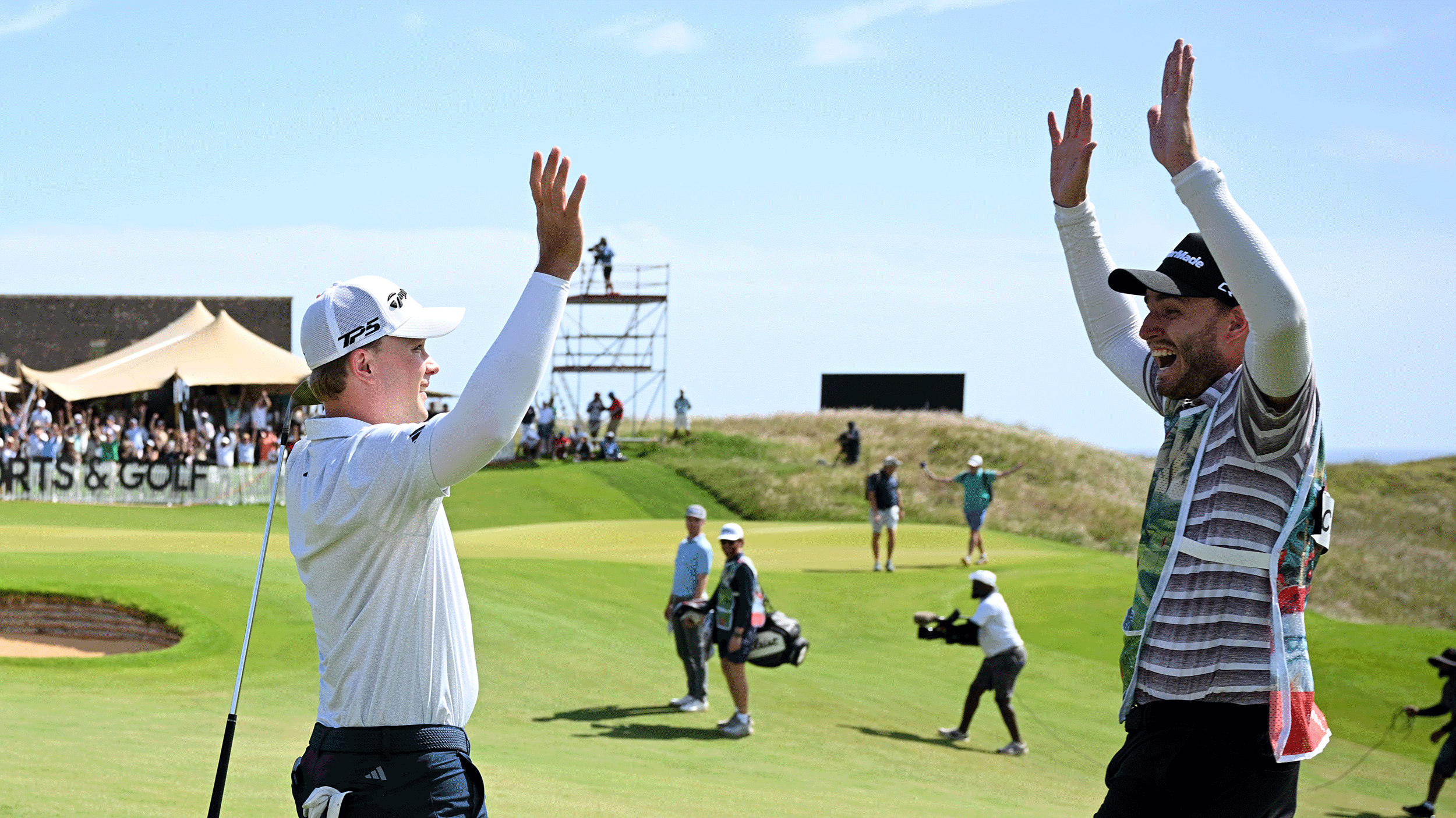 Jayden Schaper high fives his caddie after chipping in during a playoff at the 2025 AfrAsia Bank Mauritius Open