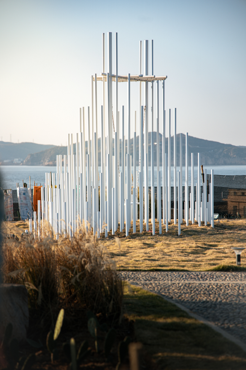forest of steel pillars creates swinging installation enveloped in cloud-like mist in china