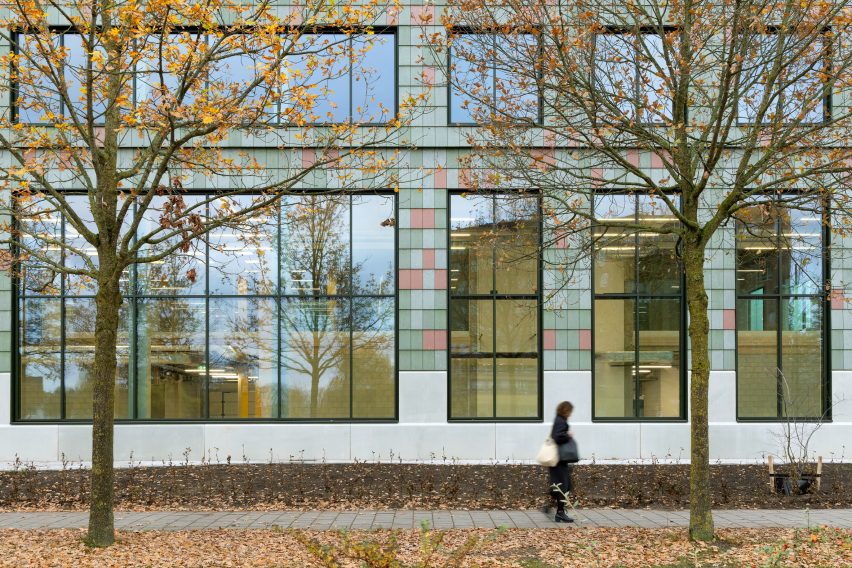 Woman walking outside tile-clad building