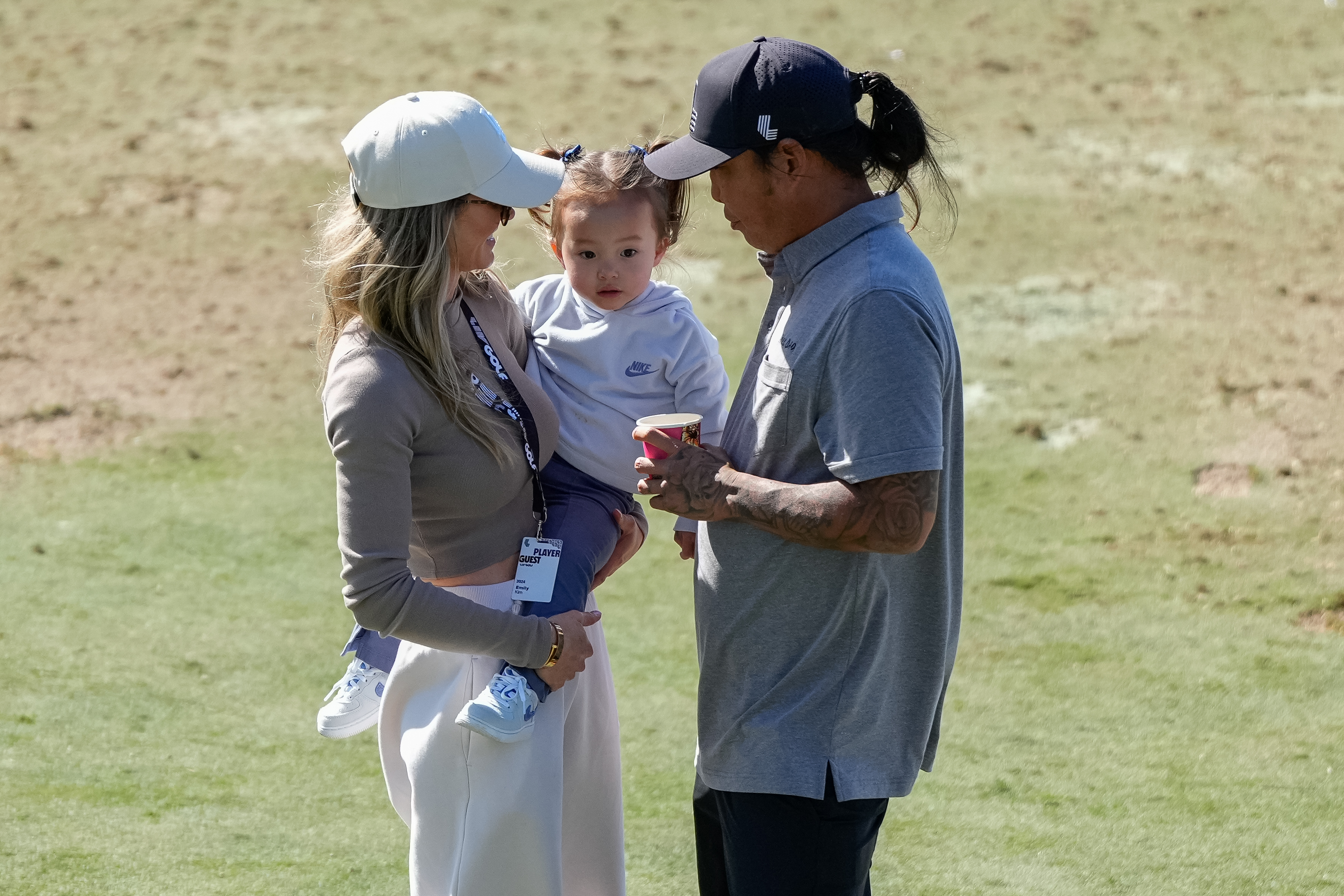Anthony Kim (right) with his wife Emily (left) who is holding their daughter Bella
