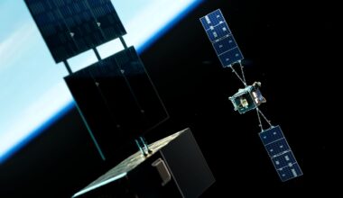 An illustration of two satellites with opposing solar panels on either side floating above the glowing blue atmosphere of Earth