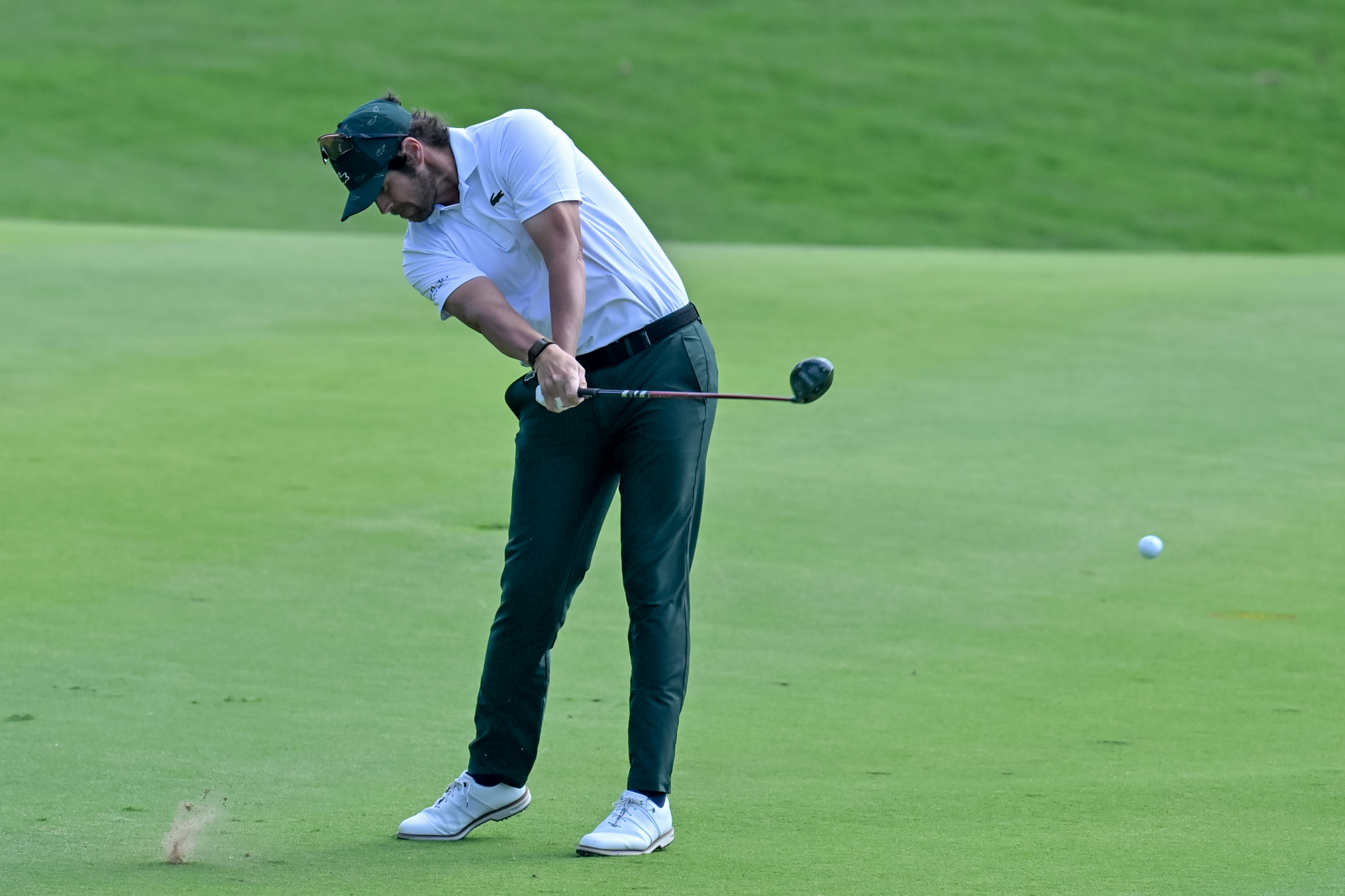 Nacho Elvira hits a fairway wood from the fairway