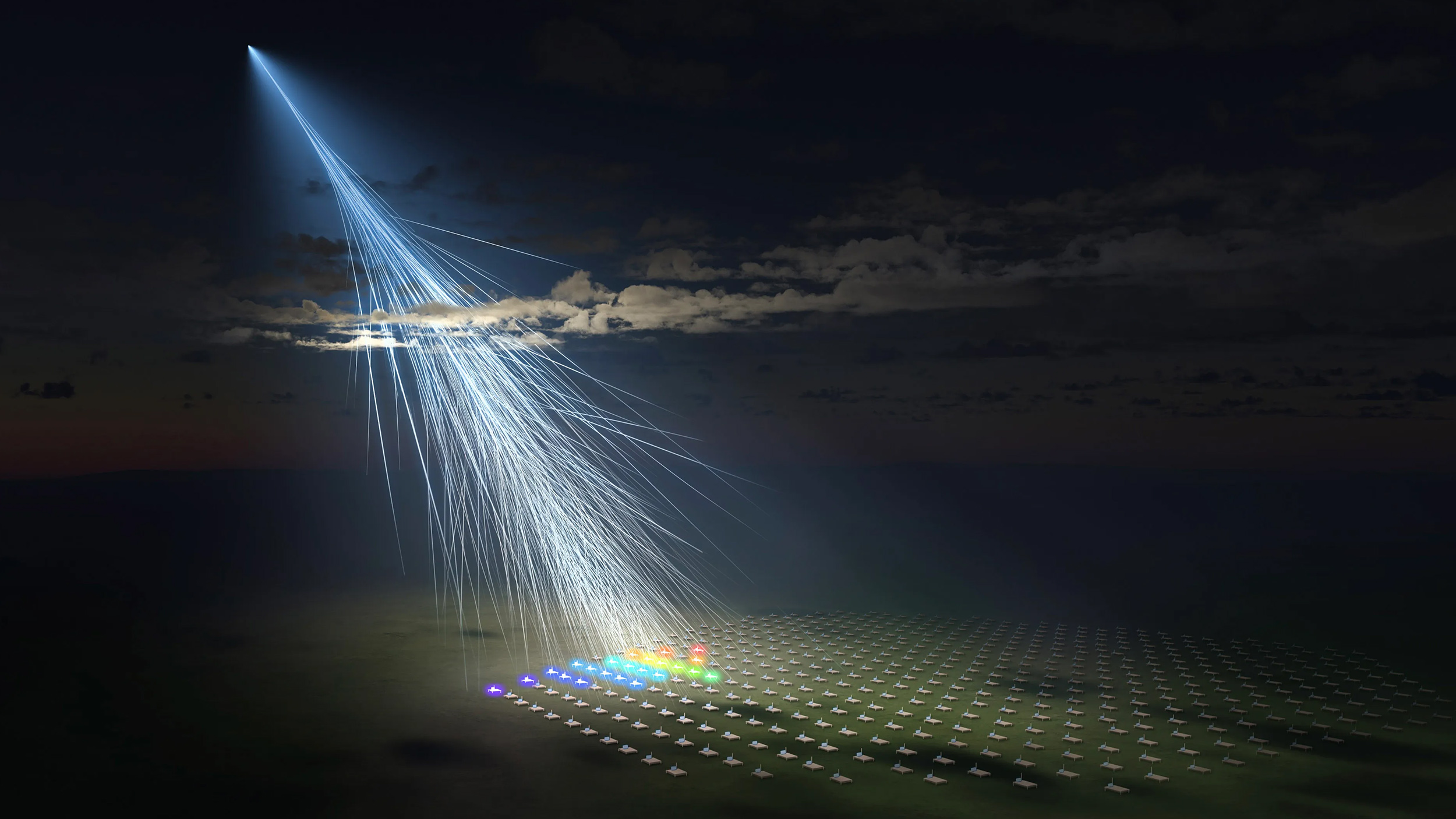 An illustration shows a cosmic ray entering Earth’s atmosphere, creating a cascade of secondary particles—some of the highest energy particles astronomers study—detected by an array of sensors on the ground.