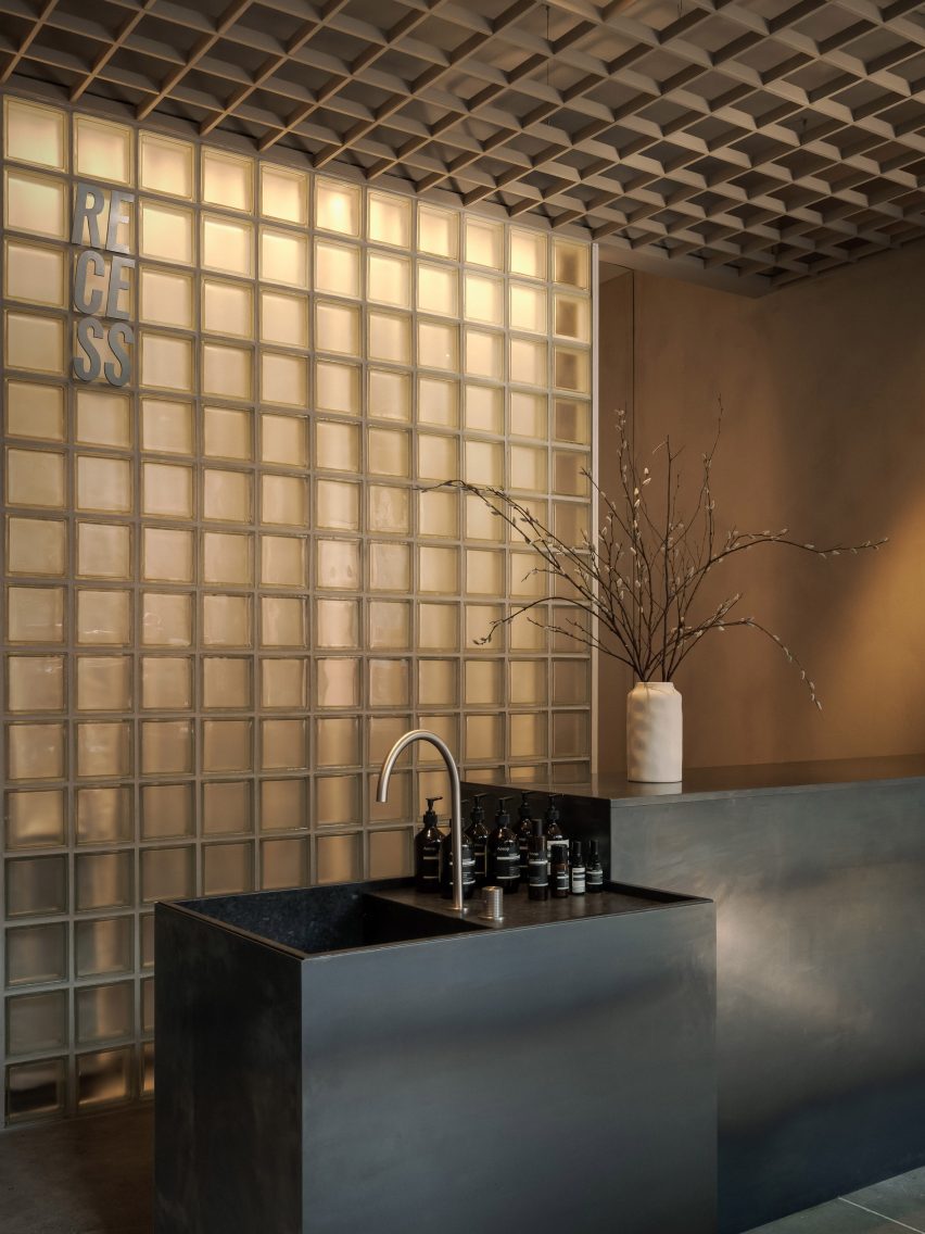 An aluminium grid containing glass blocks and the Recess logo