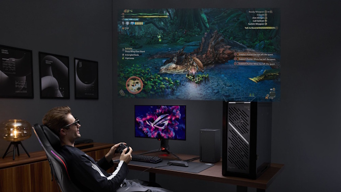A gamer playing games at a PC setup including AR gaming glasses 