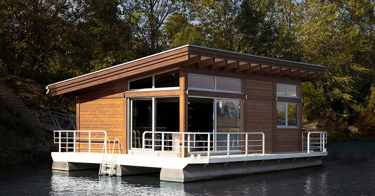 mono-pitch roof shields wooden cabin floating along river in serbia