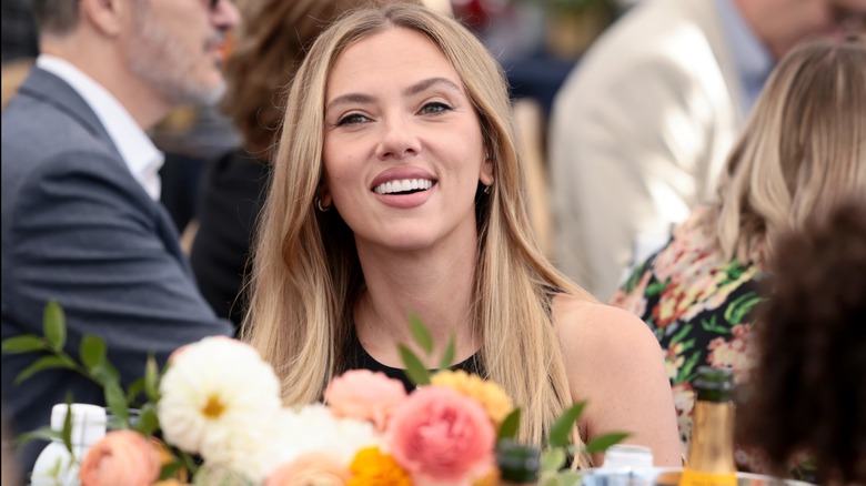Scarlet Johansson smiling at a seated dinner