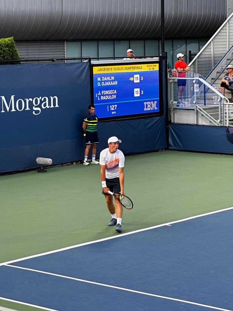 Max Dahlin winds up to serve on the baseline.