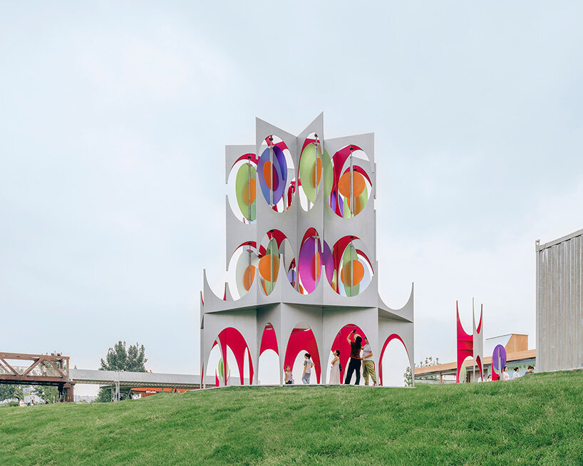 suspended colored discs move through daxing jizi design's faceted installation in beijing