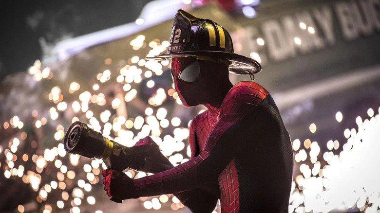 Spider-Man in a firefighter hat pointing a hose in The Amazing Spider-Man 2 (2014)