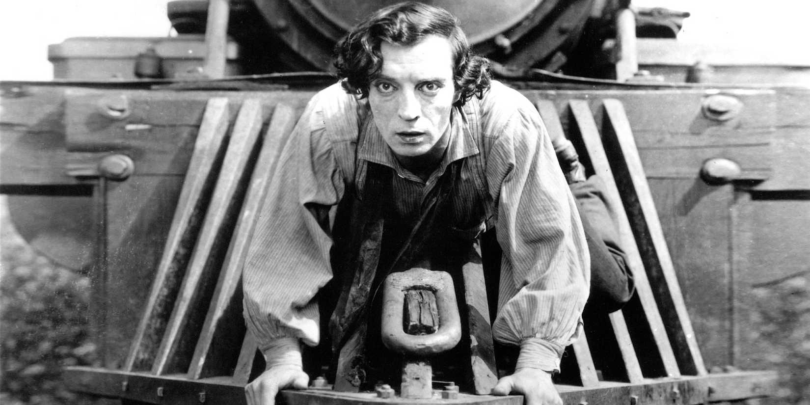 Buster Keaton on the front of a train looking ahead in The General.