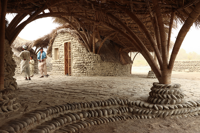 vaulted palm canopy shields dry stone guesthouse cluster in southeastern iran