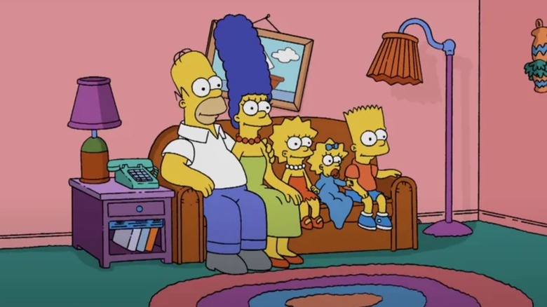 The Simpsons sat on their sofa