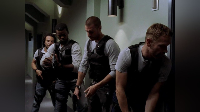 The unit prepares to breach a room in a hallway in The Unit