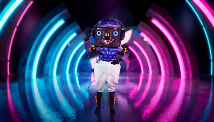 ©ITV Plc Someone dressed as a Disc Jockey with white shorts.