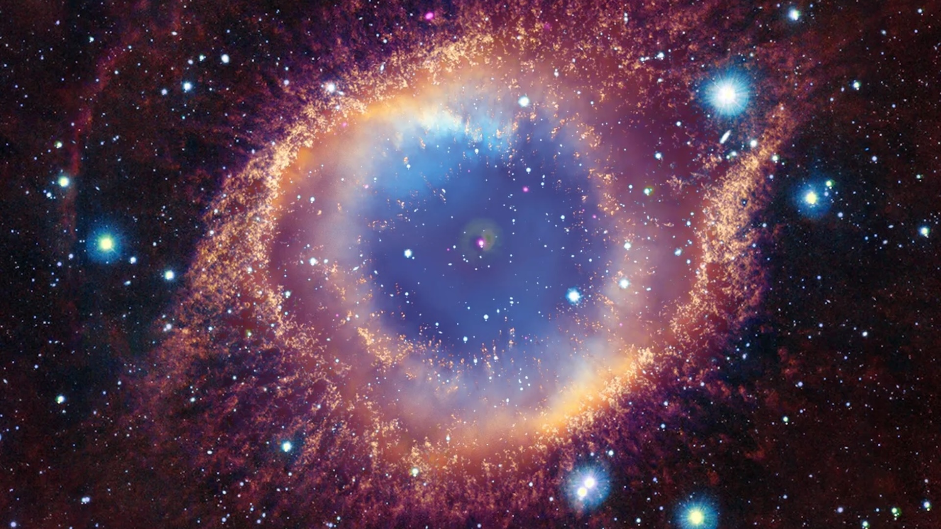 An image of a rainbow-colored round nebula