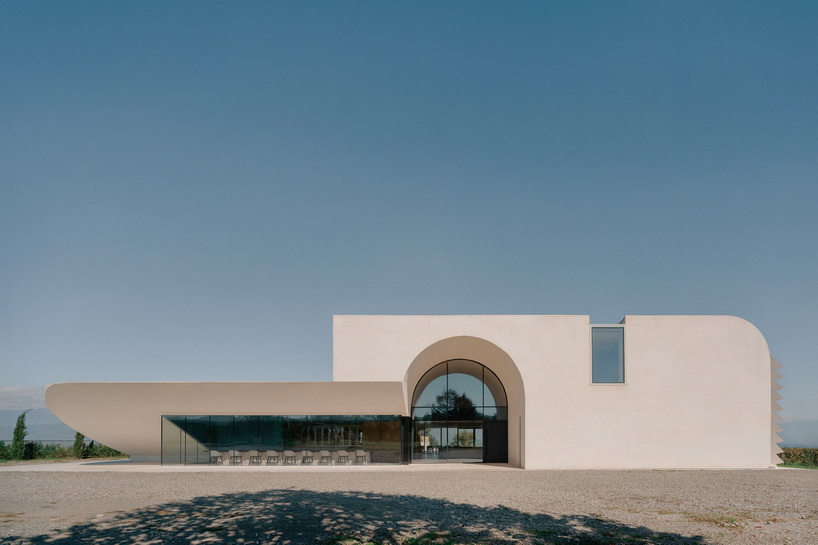 arches and voids carve winery’s monolithic white facade in georgia
