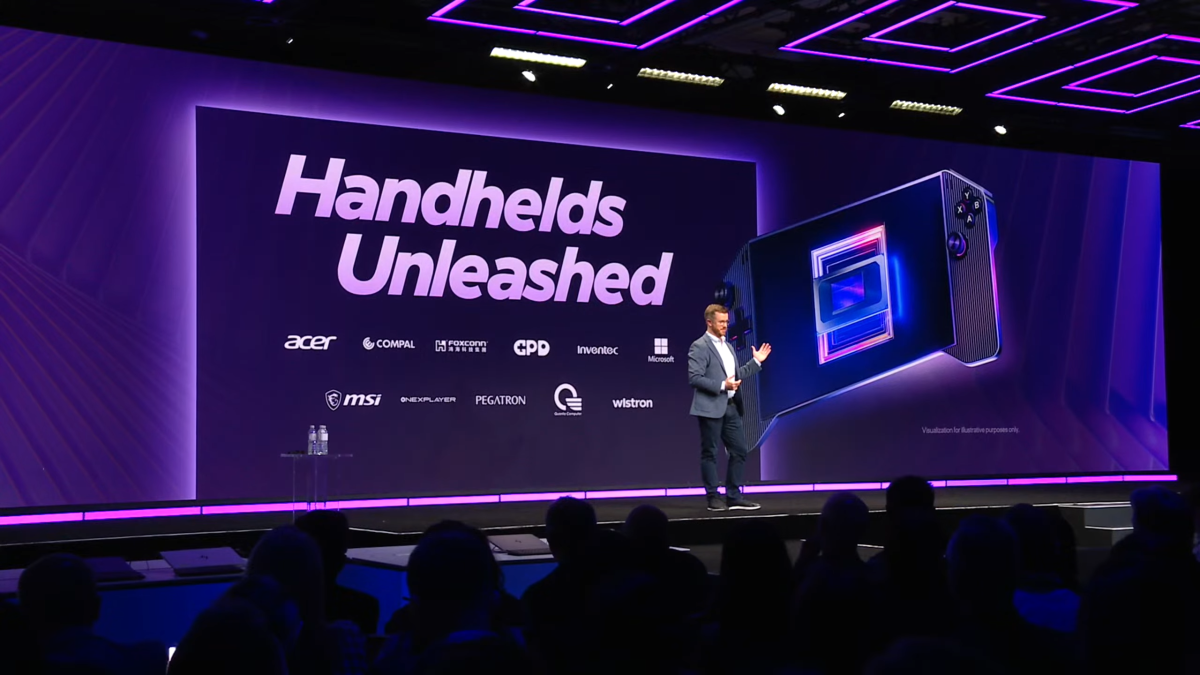 A photo of Intel’s Dan Rogers on stage at CES. He’s standing in front of a slide that says “Handhelds Unleashed”.