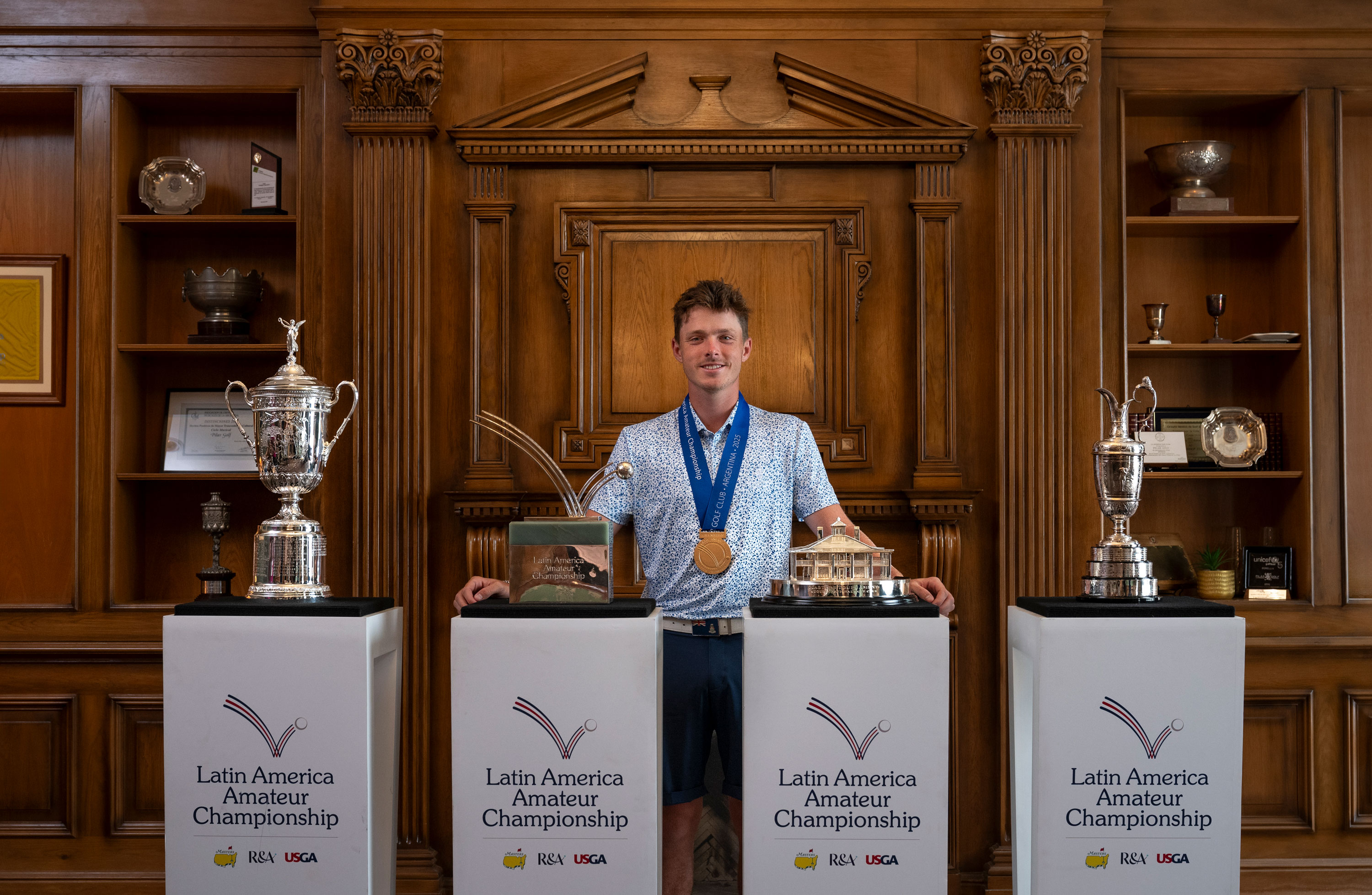 Justin Hastings with the Latin America Amateur Championship prizes