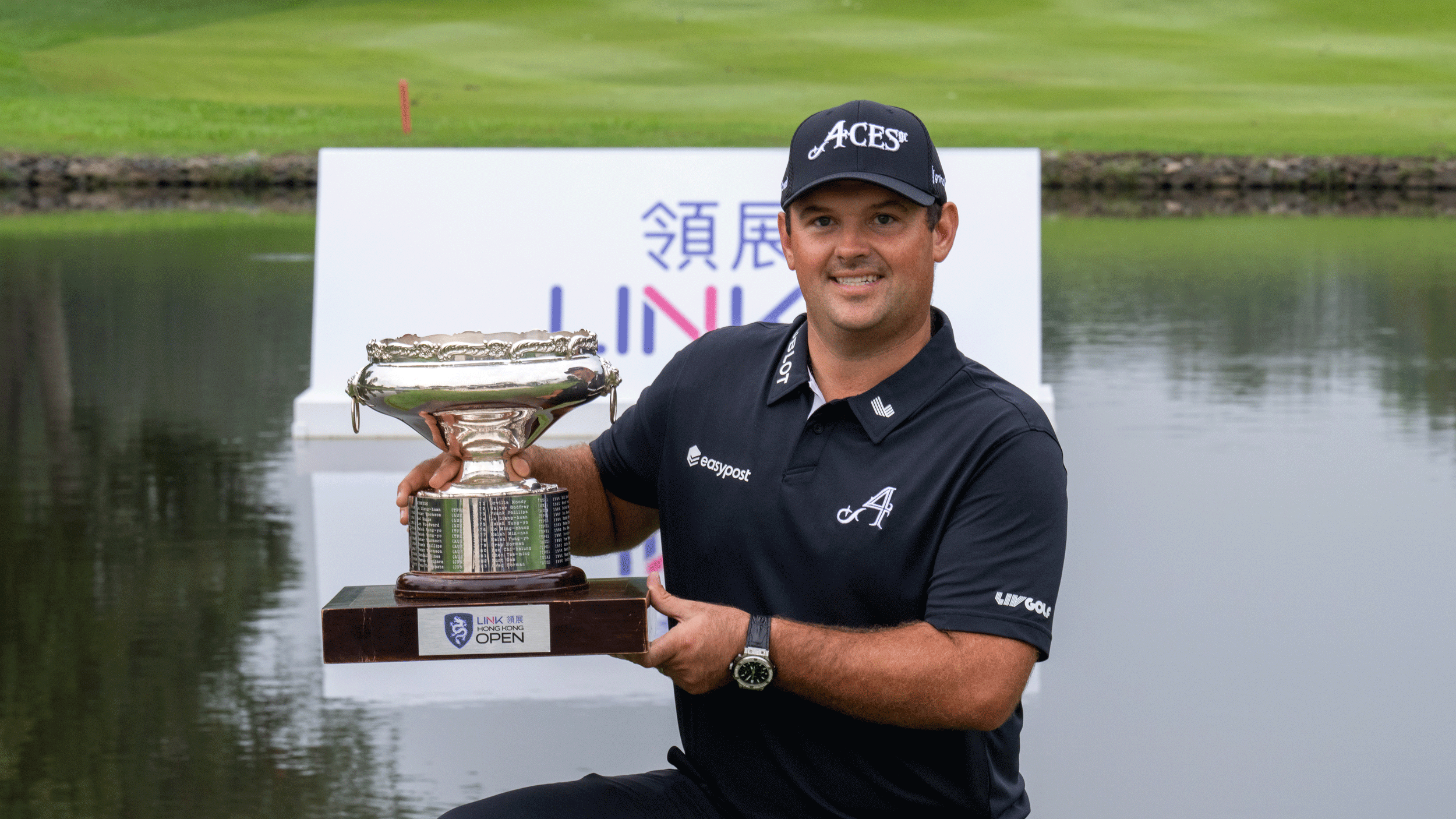 Patrick Reed holds up the Hong Kong Open trophy after his win in 2024